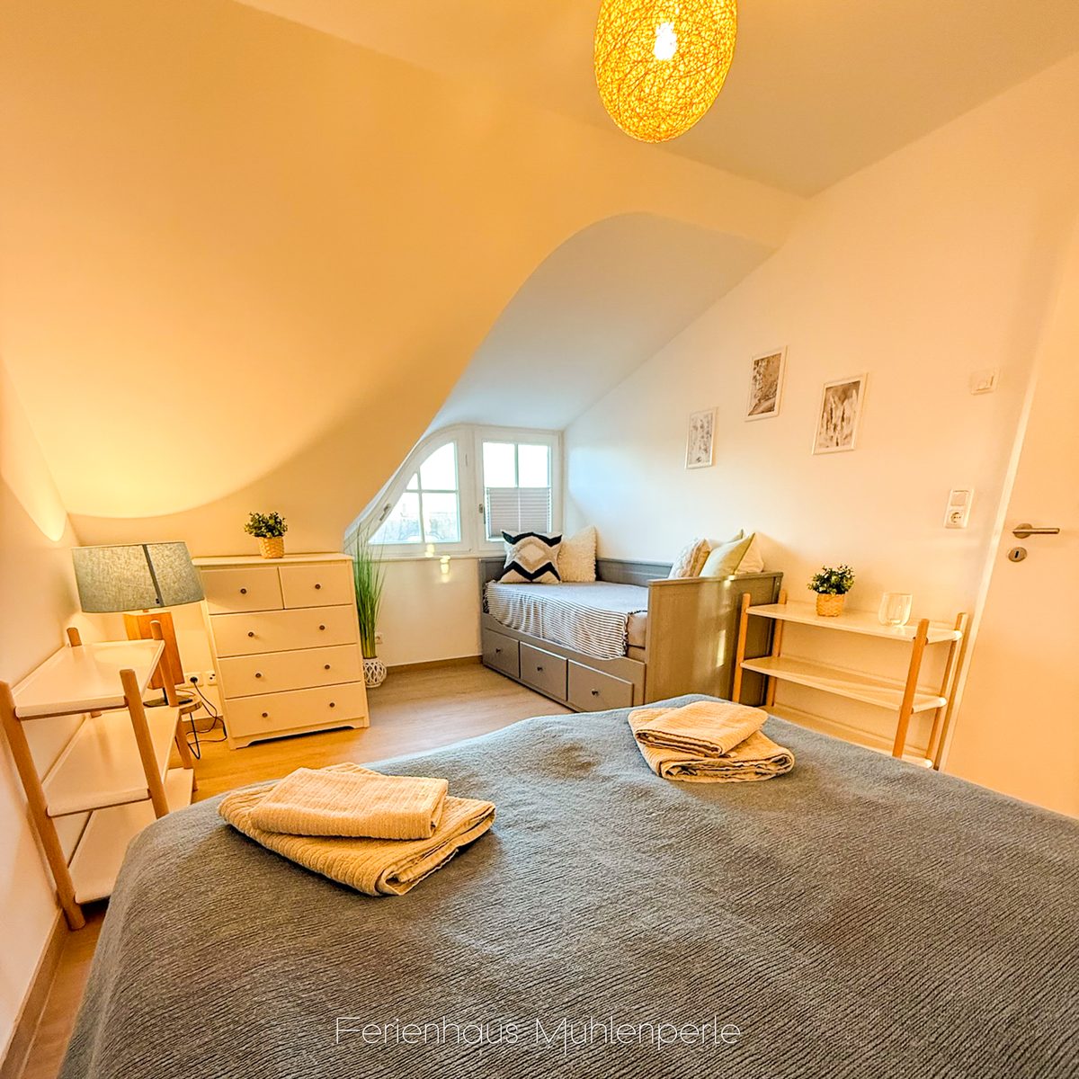Schlafzimmer mit Boxspringbett und ausziehbarem Bett im Ferienhaus Mühlenperle