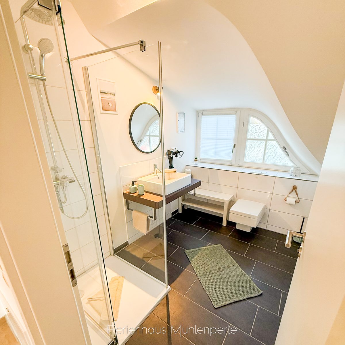 Badezimmer mit Dusche und Waschtisch im Ferienhaus Mühlenperle